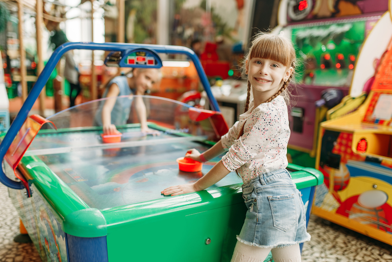 girls play air hockey