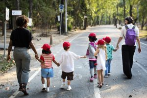 Children on field trip holding hands with teachers