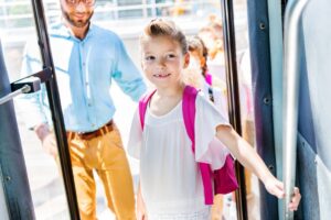 little schoolgirl entering bus