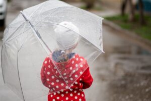 a cute little girl on the rain