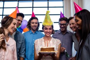 smiling coworkers celebrate birthday