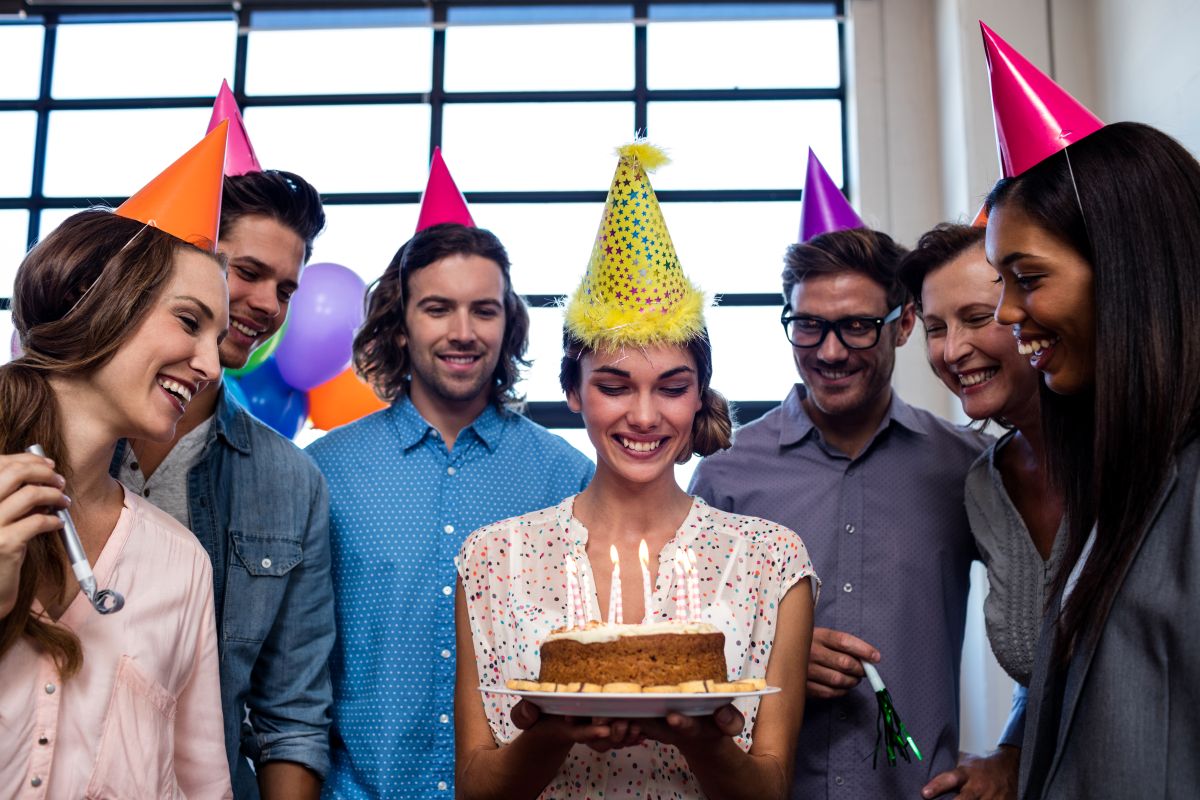 smiling coworkers celebrate birthday